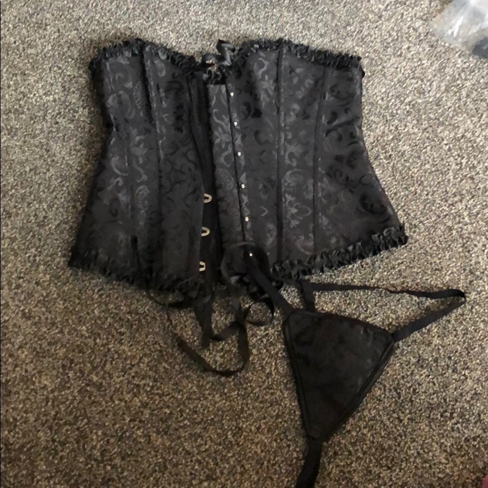 Black corset with thong underwear.
